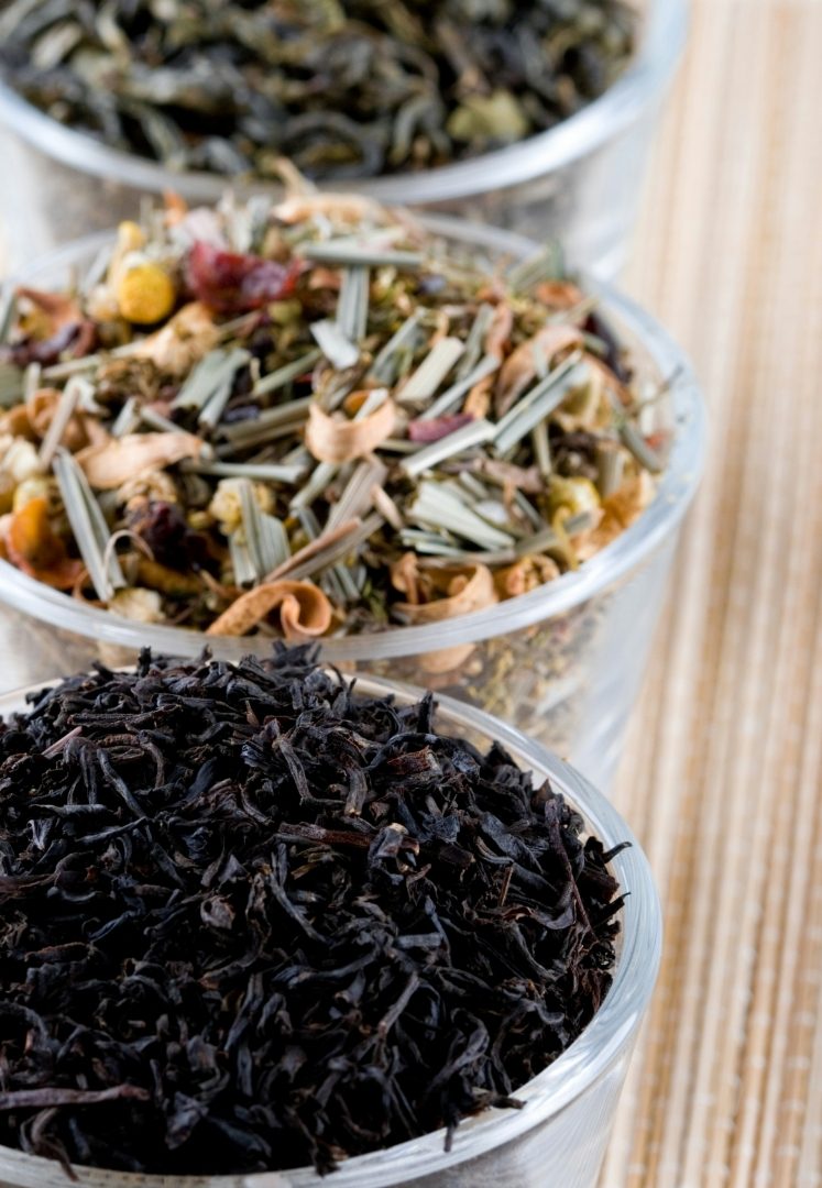 Jars of loose tea leaves at different stages of processing